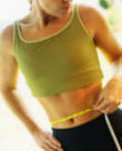 Women assessing fat loss from waist.